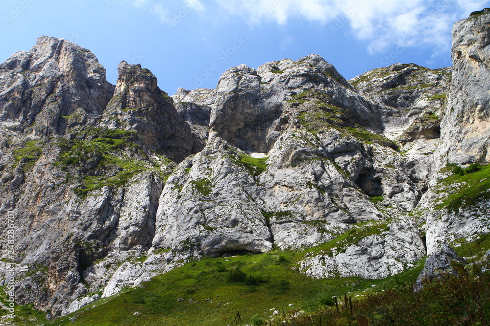 Photo of nature - fantastic stony mountain cliff with blue sky