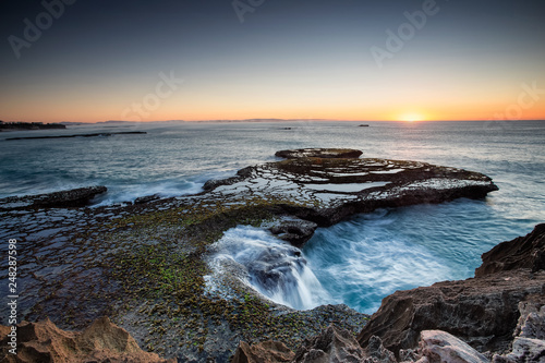 Wide angle landscape image of the dramatic sandstone rock formations along the coastline of Arniston in th Western Cape of South Africa. photo