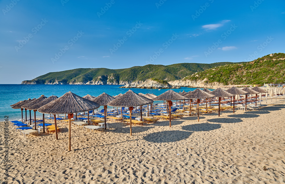 Beach with loungers and umbrellas in Greece