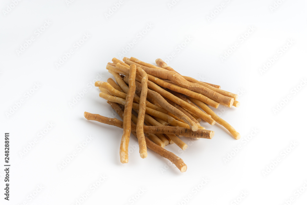 Natural toothbrush Miswak (Kayu Sugi) on white background with selective focus. It is a teeth cleaning twig made from the Salvadora persica tree and also know as miswaak, siwak, Sugi or sewak