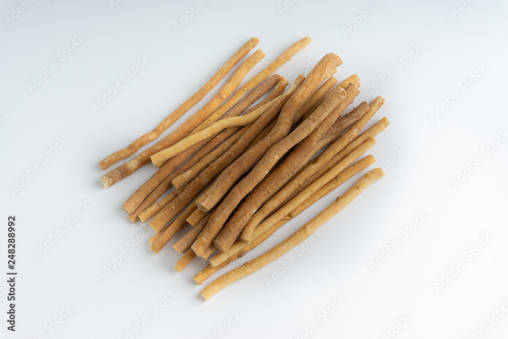 Natural toothbrush Miswak (Kayu Sugi) on white background with selective focus. It is a teeth cleaning twig made from the Salvadora persica tree and also know as miswaak, siwak, Sugi or sewak