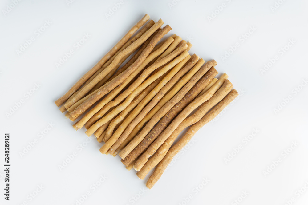 Natural toothbrush Miswak (Kayu Sugi) on white background with selective focus. It is a teeth cleaning twig made from the Salvadora persica tree and also know as miswaak, siwak, Sugi or sewak Natural toothbrush Miswak (Kayu Sugi) on white background with selective focus. It is a teeth cleaning twig made from the Salvadora persica tree and also know as miswaak, siwak, Sugi or sewak