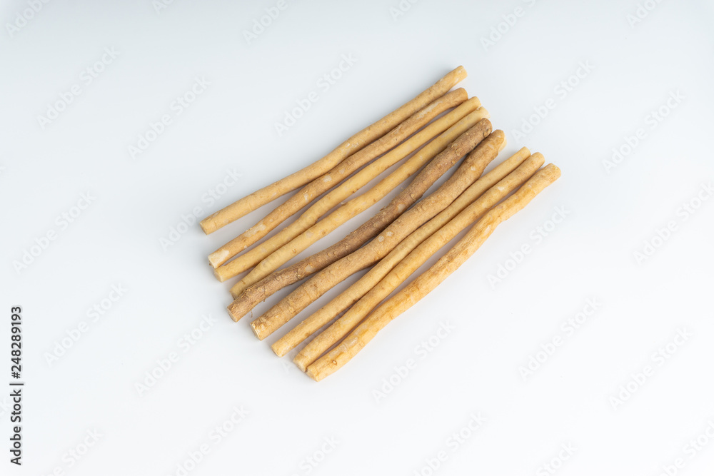 Natural toothbrush Miswak (Kayu Sugi) on white background with selective focus. It is a teeth cleaning twig made from the Salvadora persica tree and also know as miswaak, siwak, Sugi or sewak