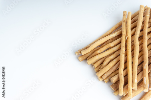 Natural toothbrush Miswak (Kayu Sugi) on white background with selective focus. It is a teeth cleaning twig made from the Salvadora persica tree and also know as miswaak, siwak, Sugi or sewak