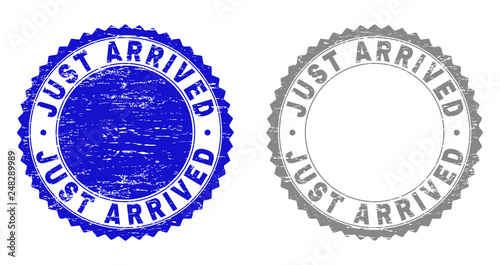 Grunge JUST ARRIVED stamp seals isolated on a white background. Rosette seals with distress texture in blue and gray colors. Vector rubber stamp imitation of JUST ARRIVED tag inside round rosette.