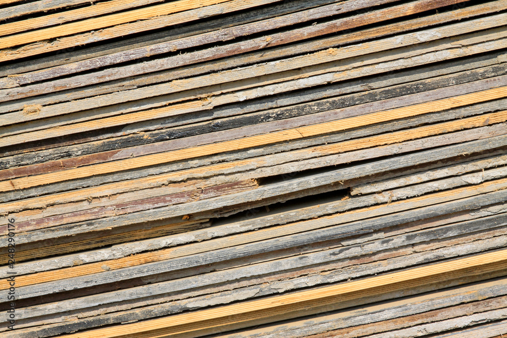plank stacked together in a construction site plank stacked together in a construction site