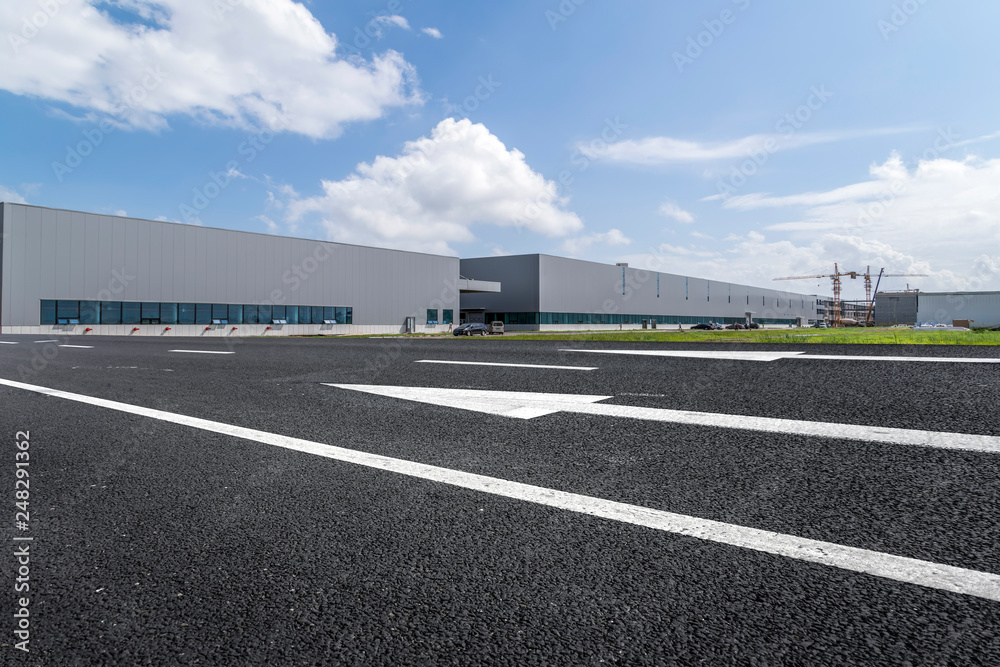 Road asphalt pavement and modern factory warehouse.. Road asphalt pavement and modern factory warehouse..