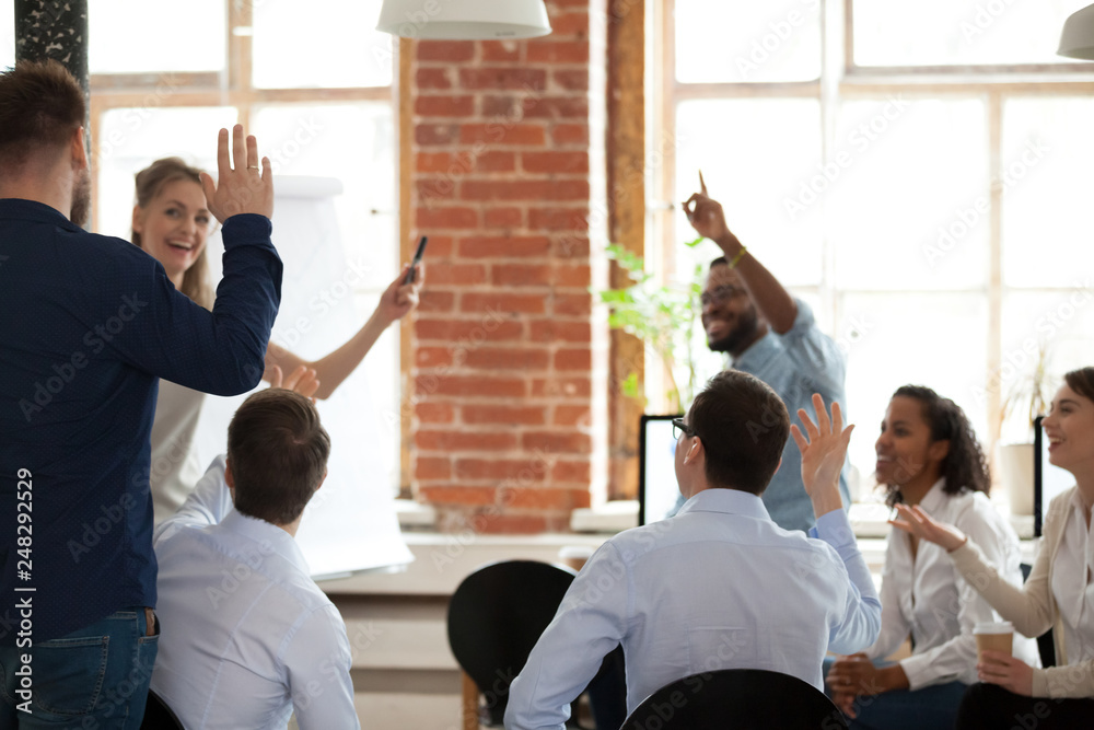 Fototapeta premium Business people raising hands voting asking questions at corporate training