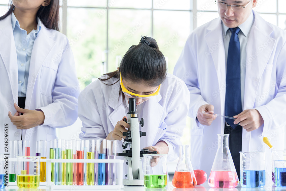 Asian young student scientist researching and learning with senior scientist have teaching in a laboratory. Asian young student scientist researching and learning with senior scientist have teaching in a laboratory.