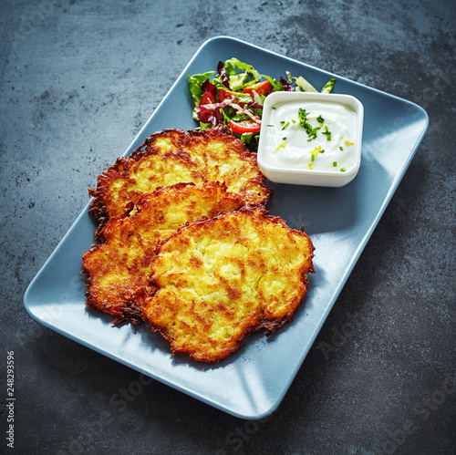 Deep fried German potato fritters with creamy dip photo