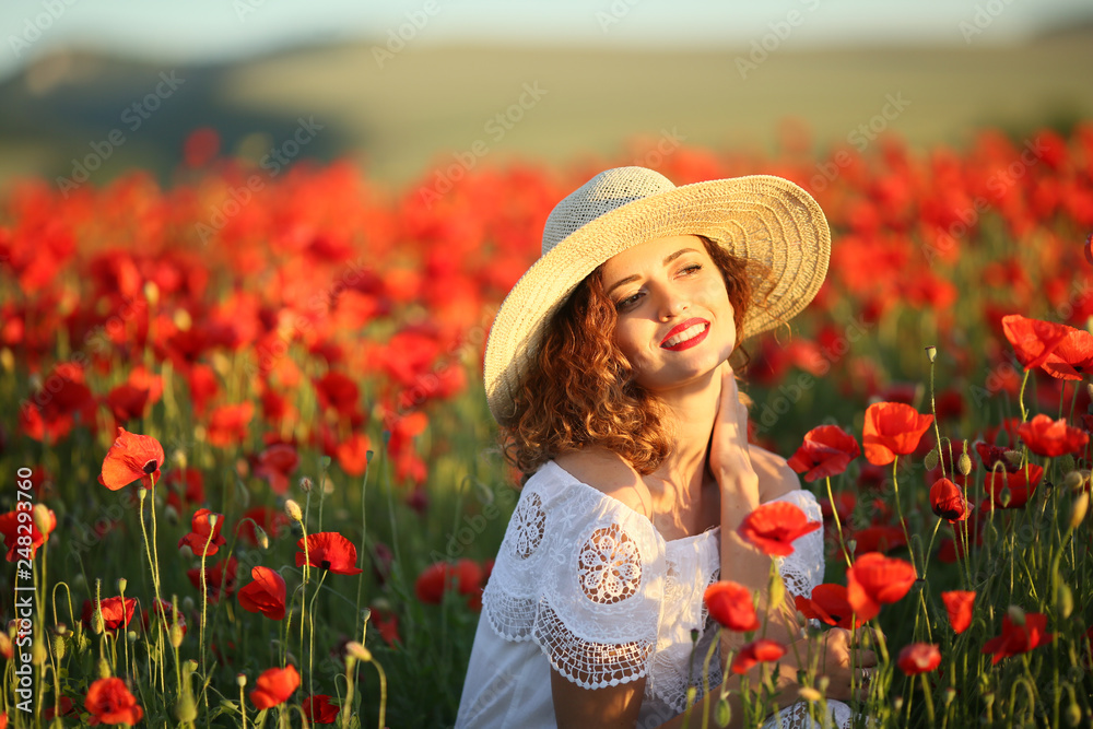 Beauty blue eyes teen enjoy summer days .Cute fancy dressed girl in poppy field. Field of blooming poppies.