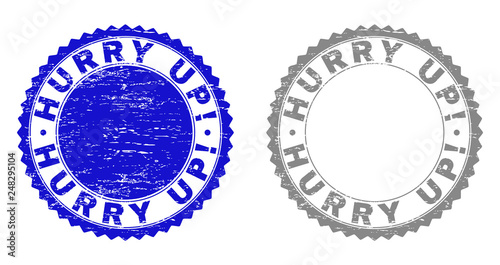 Grunge HURRY UP! stamp seals isolated on a white background. Rosette seals with grunge texture in blue and grey colors. Vector rubber stamp imitation of HURRY UP! text inside round rosette.