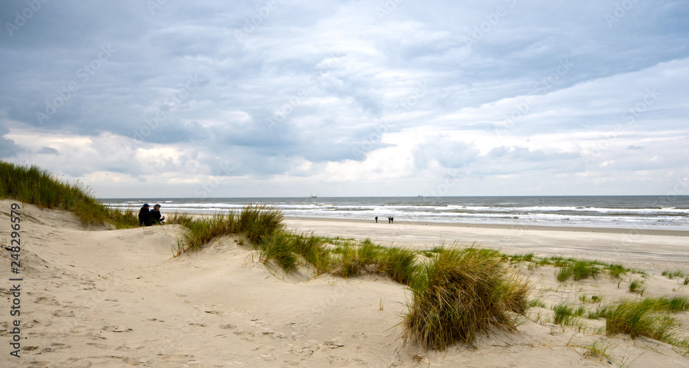 Dune beach on the North Sea island Langeoog in Germany with clouds on a beautiful summer day, holidays in Europe