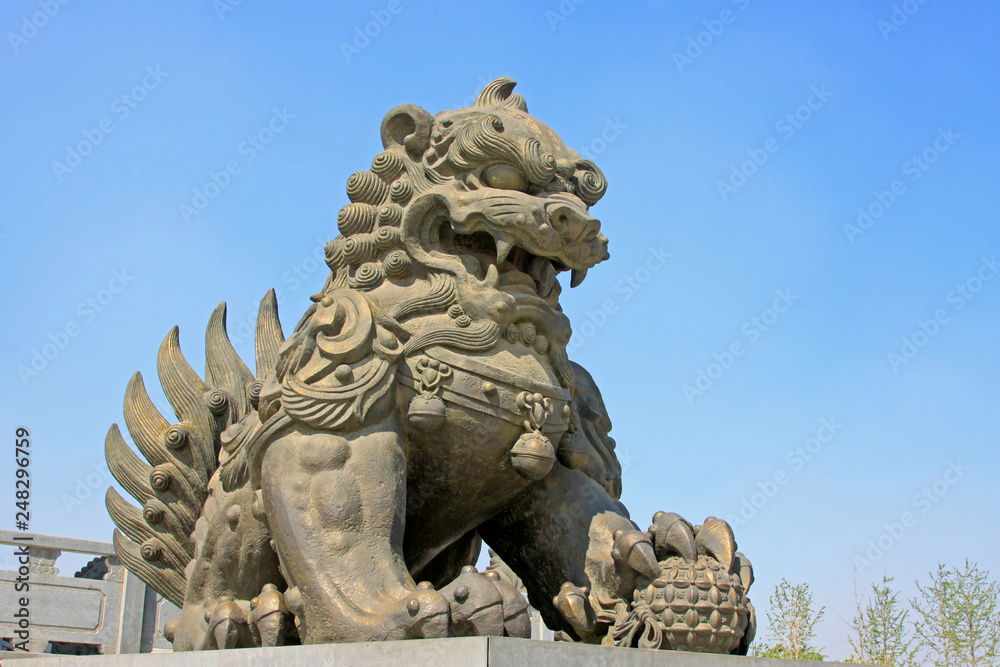 copper lion sculpture in a park, China