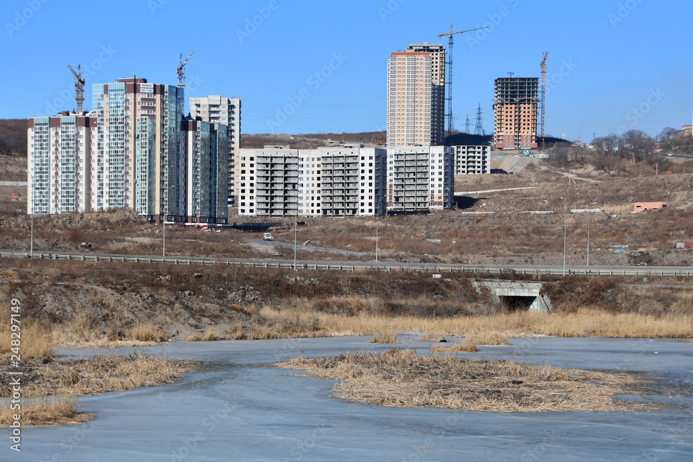 Russia, Vladivostok, Patrokl. New buildings on Sochinskaya street and unnamed lake on Patrokl in the winter