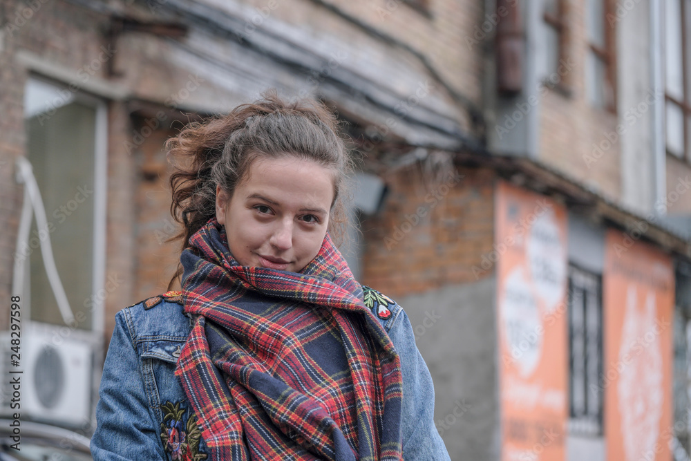 Fototapeta premium Beautiful attractive girl in a red checkered scarf