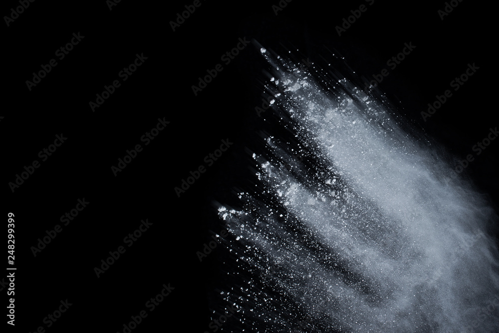 White powder explosion on black background. Colored cloud. Colorful dust explode. Paint Holi.