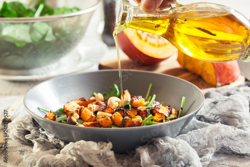 Roasted pumpkin salad with spinach and nuts