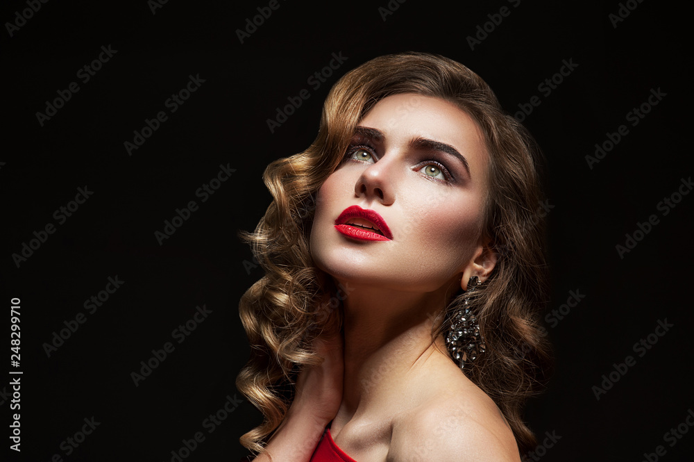 Fototapeta premium Woman with red lips on black background