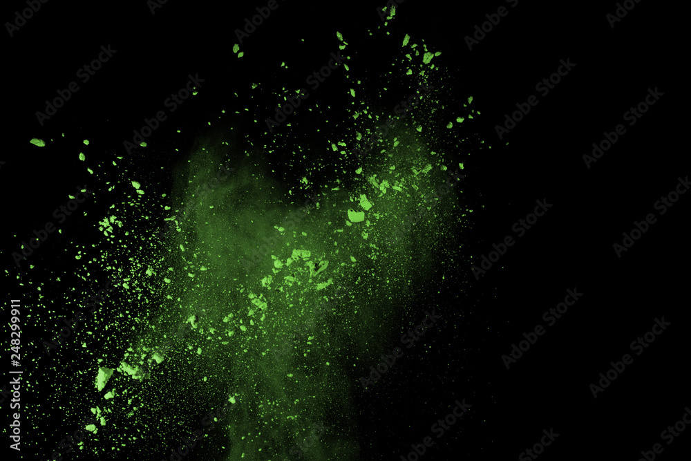 Obraz premium The movement of abstract dust explosion frozen green on black background. Stop the movement of powdered green on black background. Explosive powder green on black background.