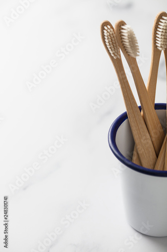 Wooden bamboo toothbrushs in a white pot