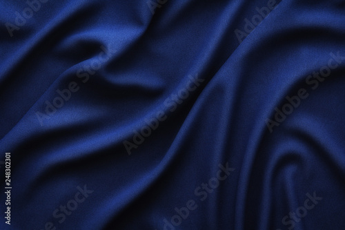 dark blue fabric with large folds, textile background