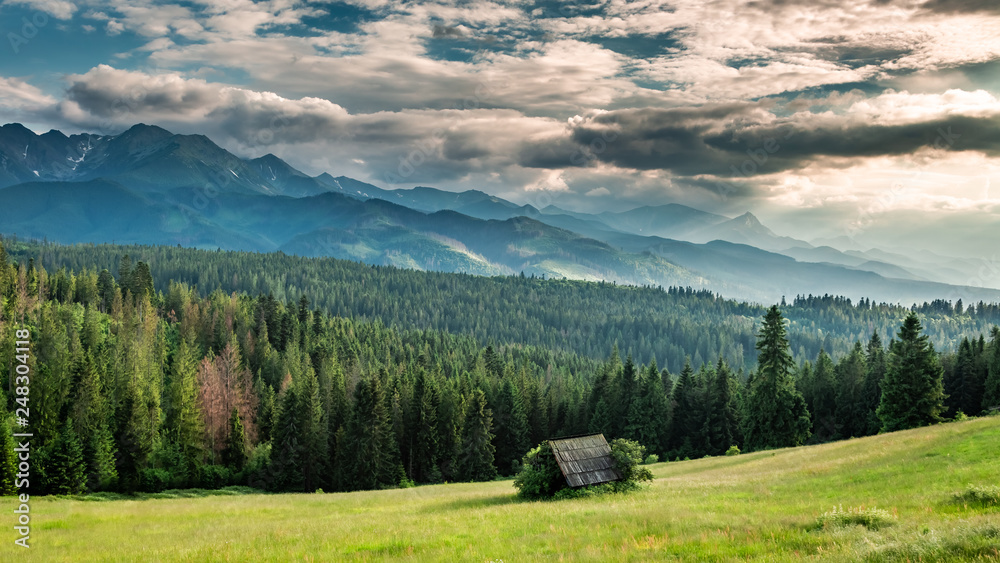 Small cottage on green valley at sunset, Tatra mountains