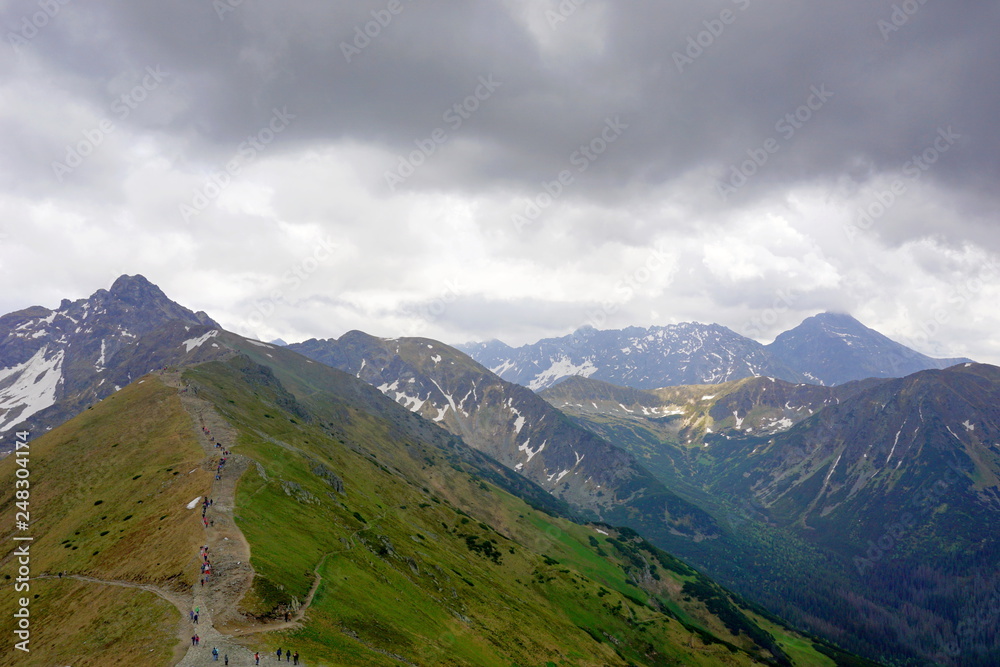 Fototapeta premium Tatra Mountains, Poland. View from Kasprowy Wierch to Swinica mount, tourists on the trail