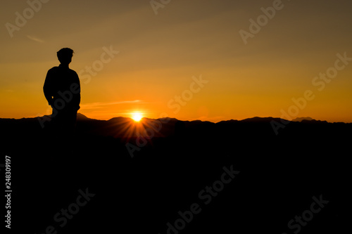 Silhouette of man at sunset, Concept lifestyle freedom vacation travel.