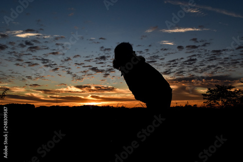 Silhouette woman at sunrise.