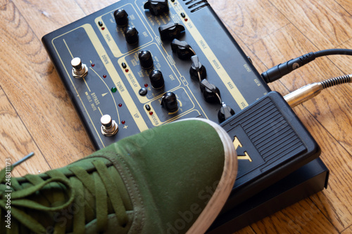 guitarist foot on guitar effect pedal in a studio