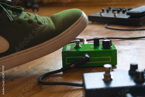 guitarist foot on guitar effect pedal in a studio photo