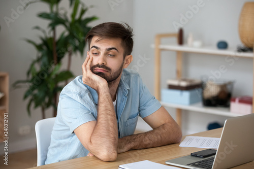 Εκτύπωση καμβά Tired worker wasting time at workplace distracted from boring job