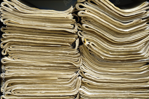 Stacks of old papers on black background