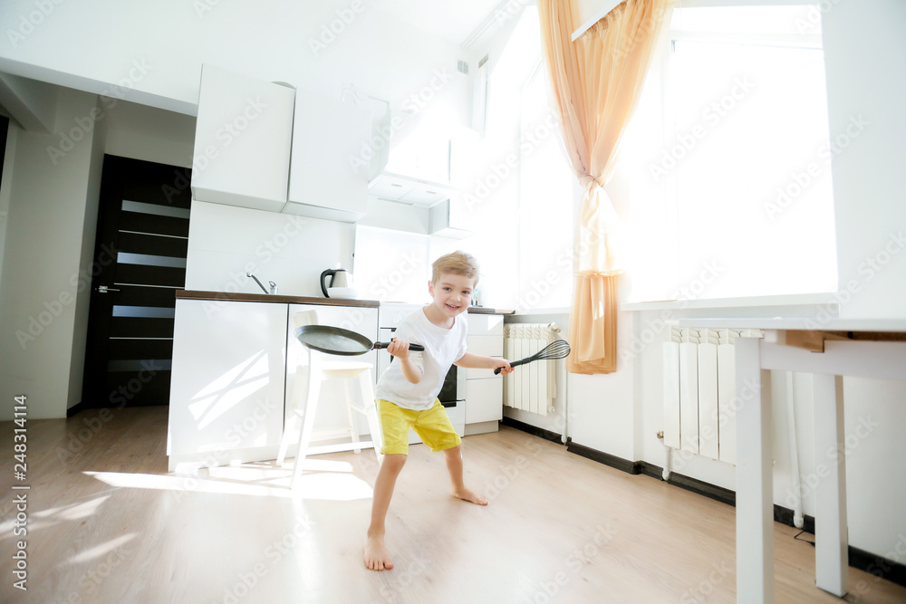 funny European little boy chef dancing,Happy weekend, boy wants to make pancakes, but the frying pan are too gay, he decided to have fun holding wooden spoons in his hands, having fun while cooking funny European little boy chef dancing,Happy weekend, boy wants to make pancakes, but the frying pan are too gay, he decided to have fun holding wooden spoons in his hands, having fun while cooking