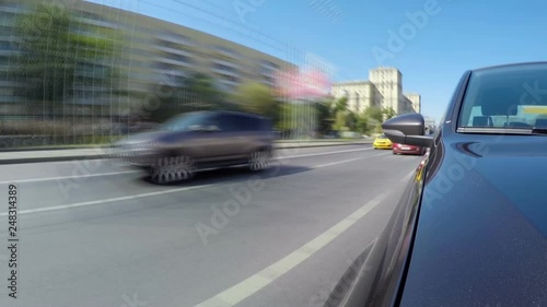 Time lapse of car moves along the city street on sunny summer day. Front view from the car body.