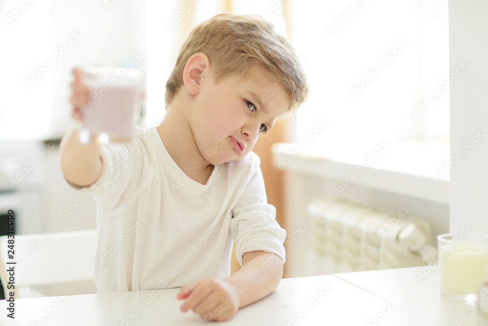 Sweet preschool child in the kitchen, making pancakes in the morning Sweet preschool child in the kitchen, making pancakes in the morning