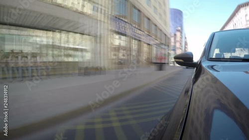 Time lapse of car moves along the city street on sunny summer day. Front view from the car body.