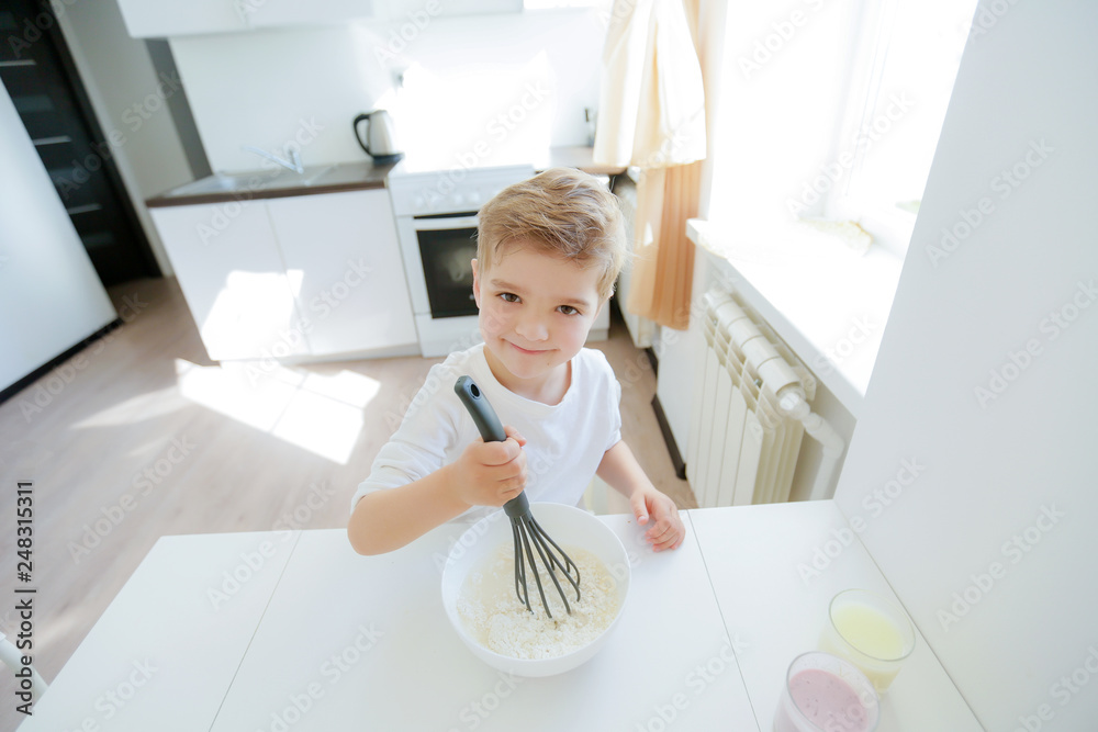 Five years boy enjoy cooking making pancakes in the morning, happy childhood Five years boy enjoy cooking making pancakes in the morning, happy childhood