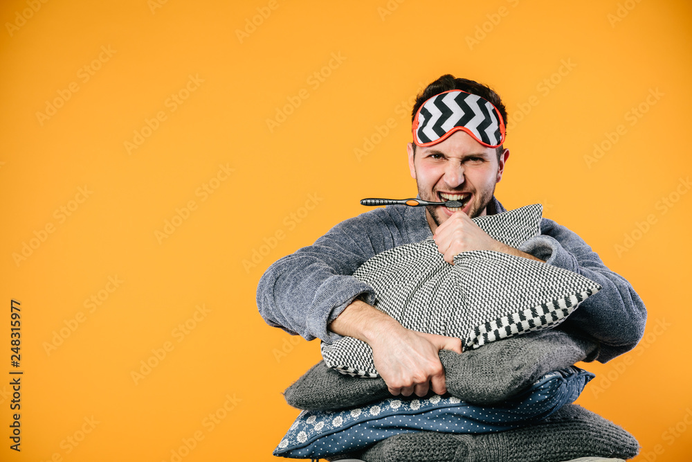 people, bedtime and rest concept. Handsome smiling young man in luxurious bathrobe.