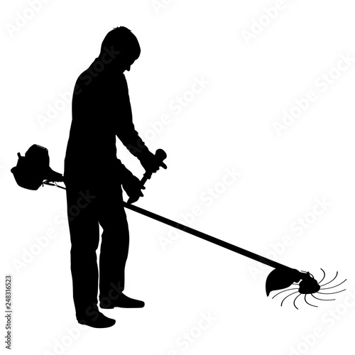 Silhouette worker of a garden cuts off grass.