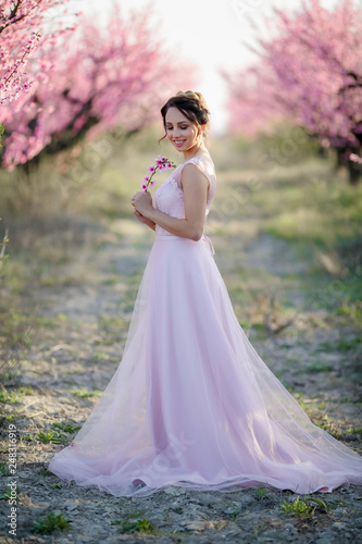 Young beautiful bride in the flowered garden.