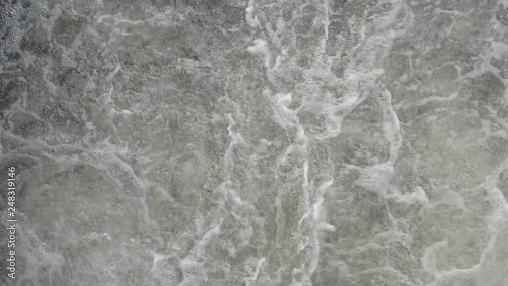 Turbulent water gushing spurts at the base of a dam Turbulent water gushing spurts at the base of a dam