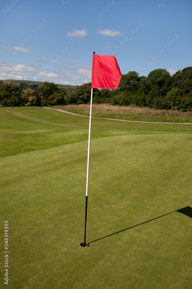Obraz premium Red Flag on a Golf Course marking the hole