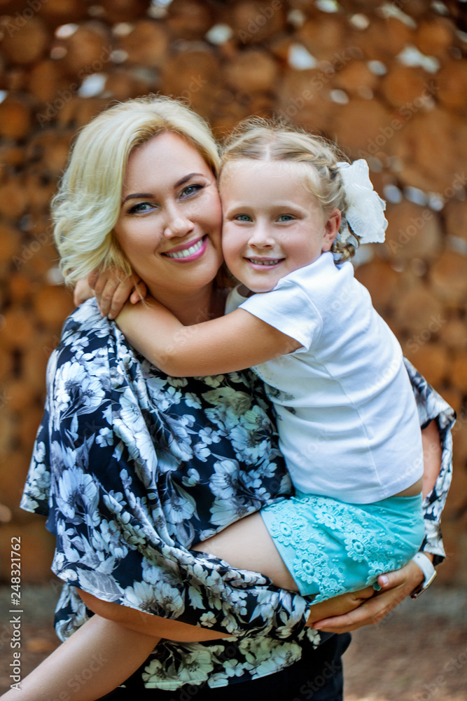 Obraz premium Joyful hug mothers and daughters. Parental care