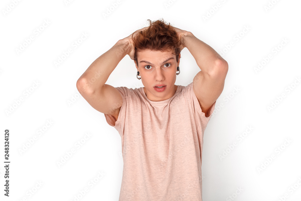 Teenager with earrings studio standing isolated on white holding head concerned close-up Teenager with earrings studio standing isolated on white holding head concerned close-up