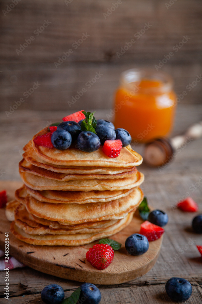 Pancakes with berries and maple syrup and sugar powder Pancakes with berries and maple syrup and sugar powder