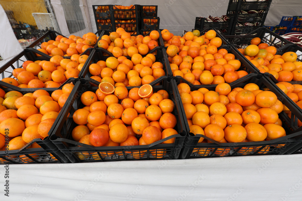 boxes full of fresh ripe oranges for sale at the local market