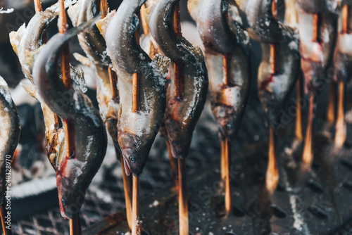 Salt-Crusted Grilled Ayu fish (Ayu Sweetfish) with charcoal, Traditional food in Japan. photo