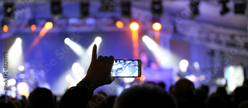 Bild auf Leinwand person with the pinky hand raised while photographing the rock c